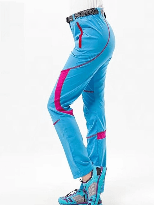 Side view of blue and pink women's quick-drying hiking pants with breathable Drytek material, ideal for outdoor adventures.